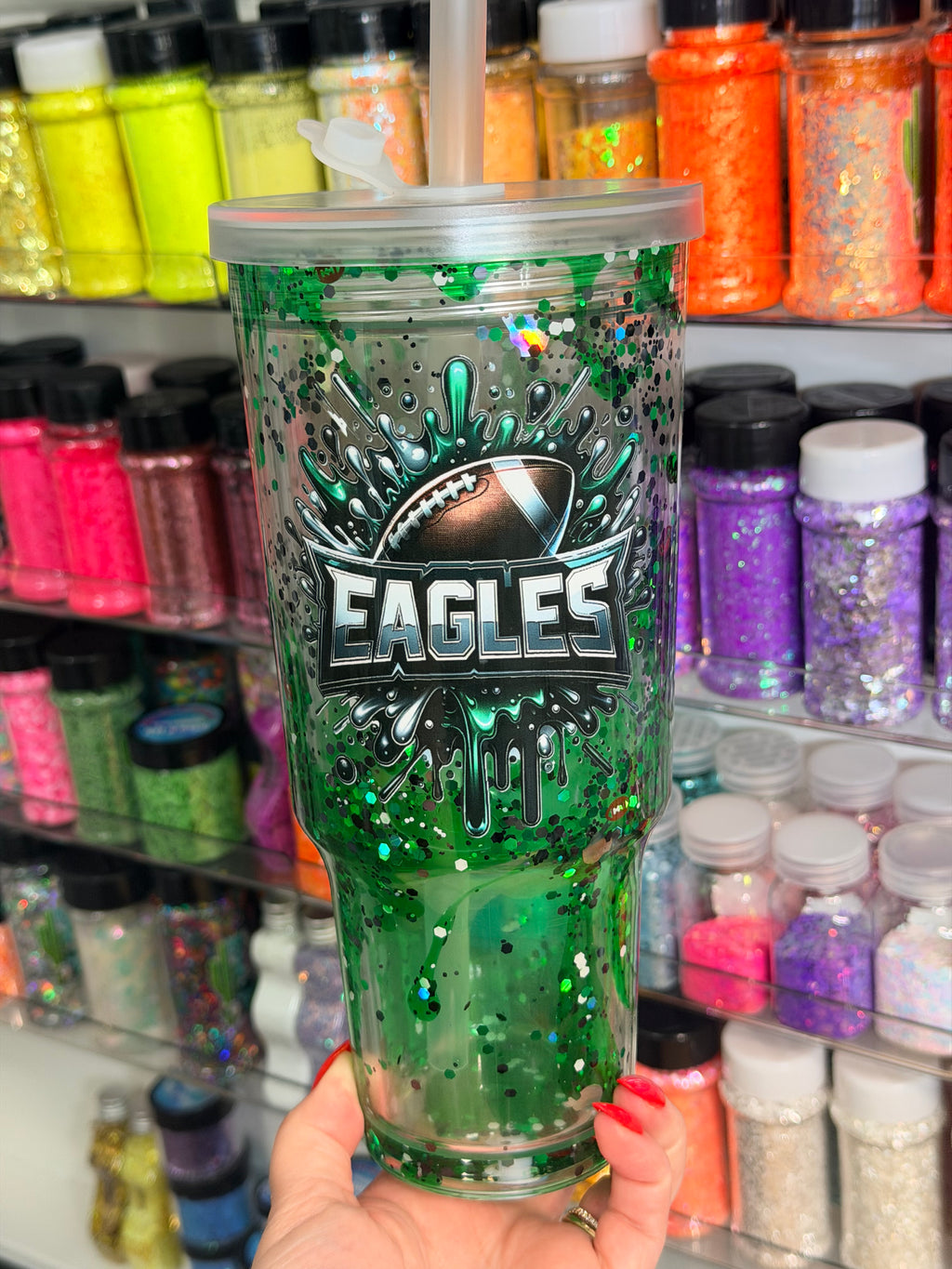 Green acrylic lava tumbler with Eagles logo, speckled drip graphic and clear lid