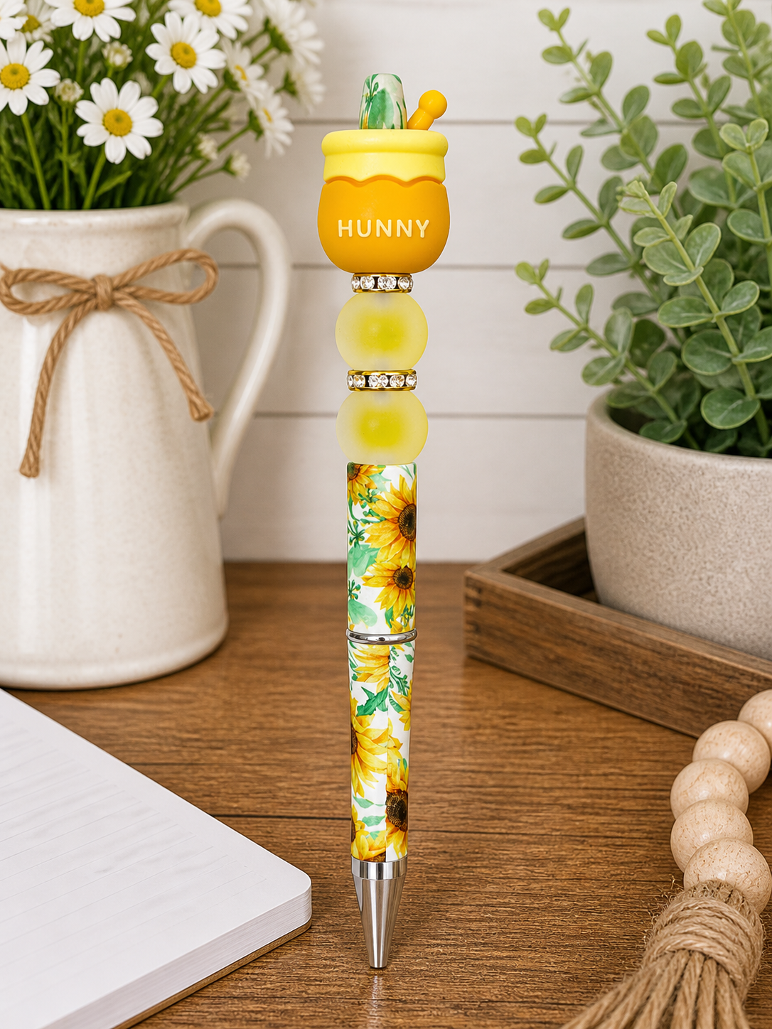 Honey pot pen with yellow cap marked HUNNY and floral yellow-green barrel