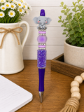 Elephant-faced pen with purple glitter barrel, purple cap, and bead ring details