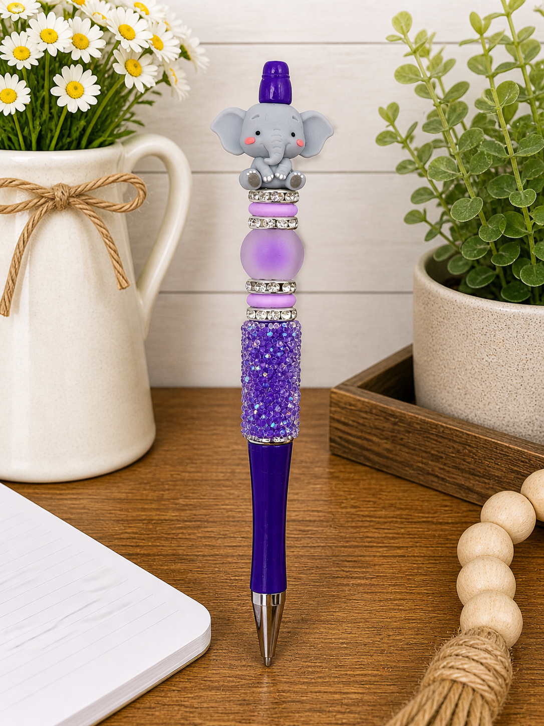 Elephant-faced pen with purple glitter barrel, purple cap, and bead ring details
