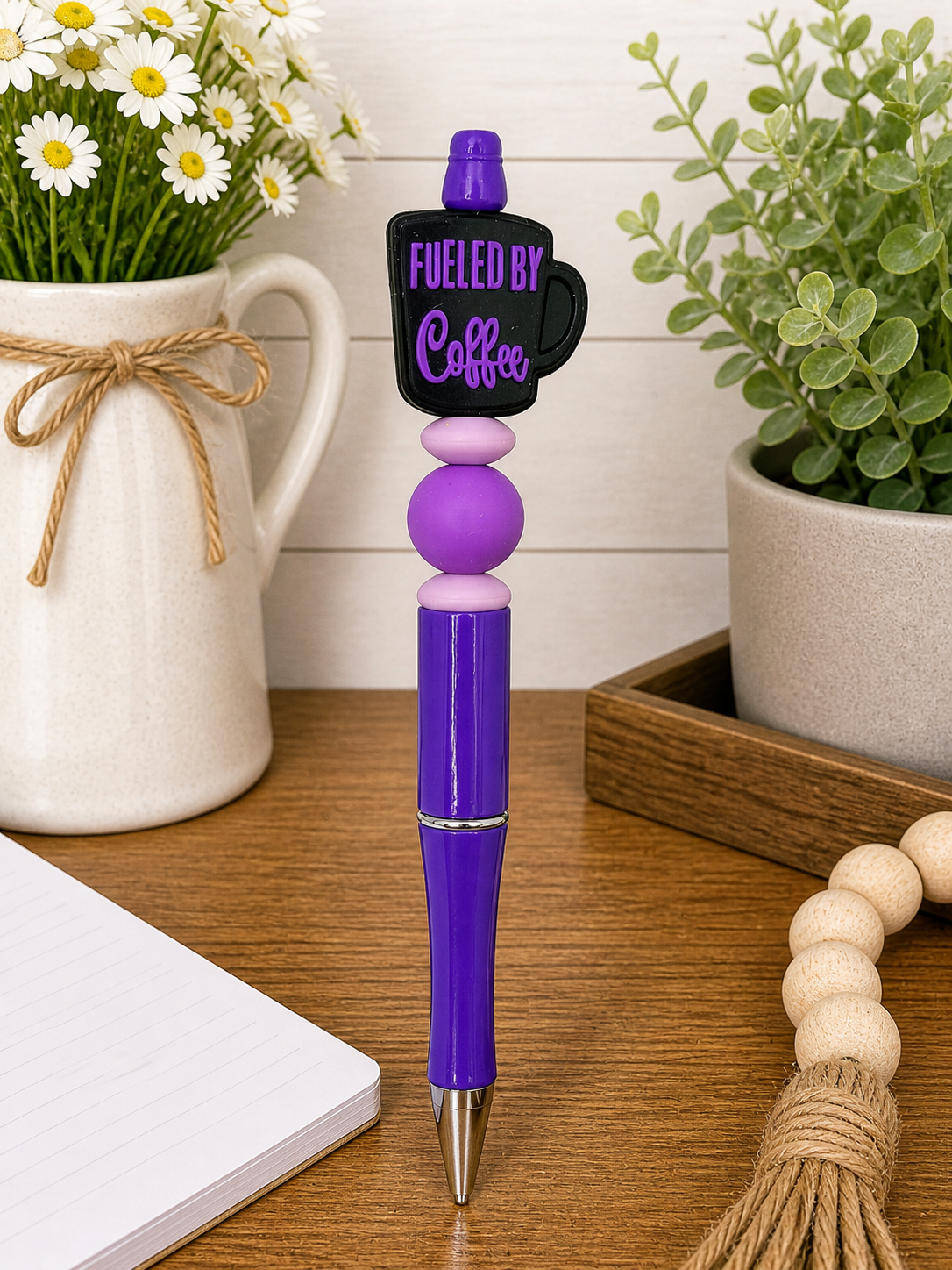 Purple fueled-by-coffee novelty pen with rounded bead grip and ink tip
