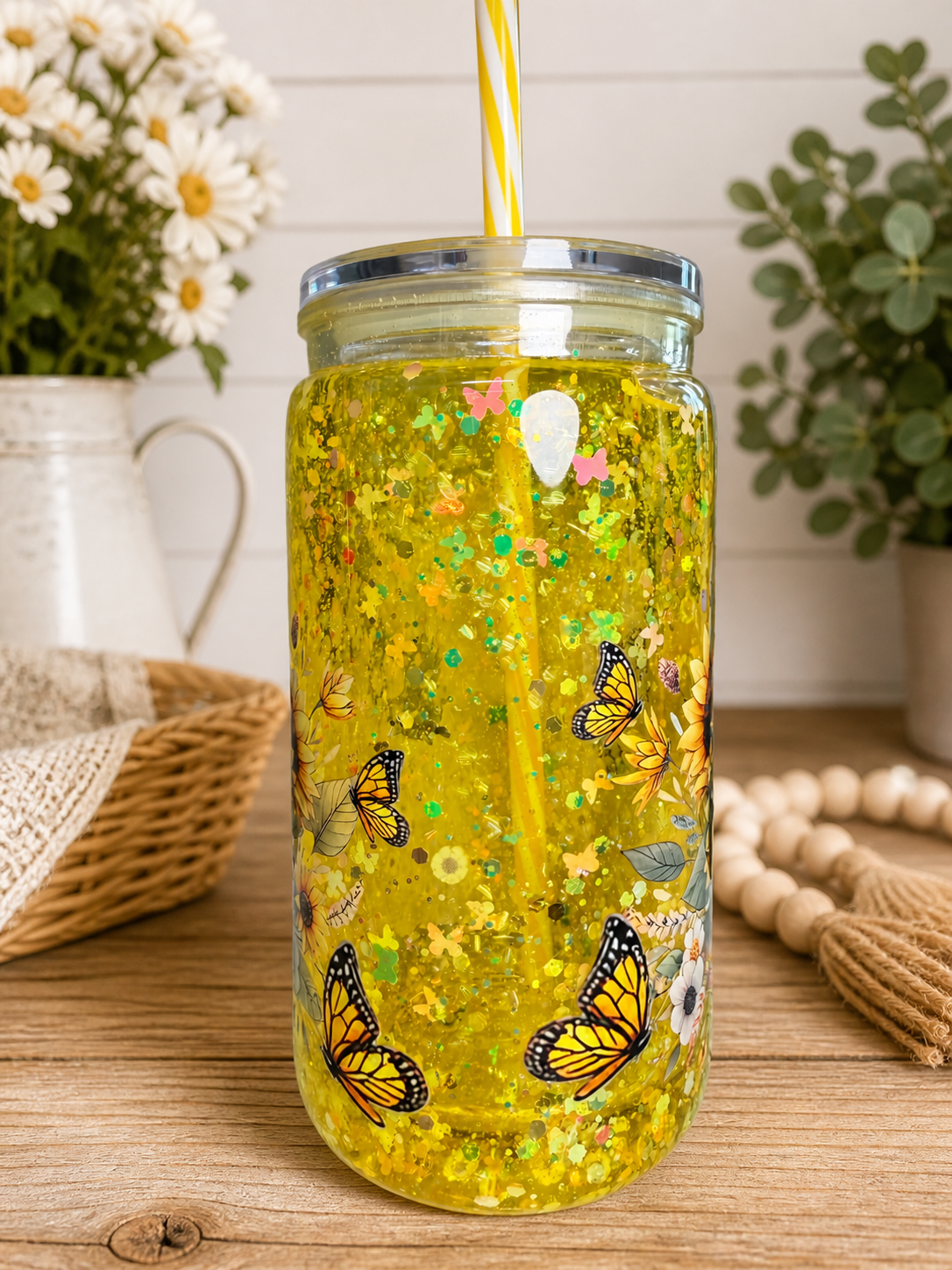 Acrylic snow globe cup with butterfly print and yellow glitter; clear lid