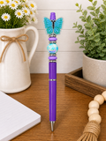 Purple butterfly pen with turquoise butterfly top and blue bead center
