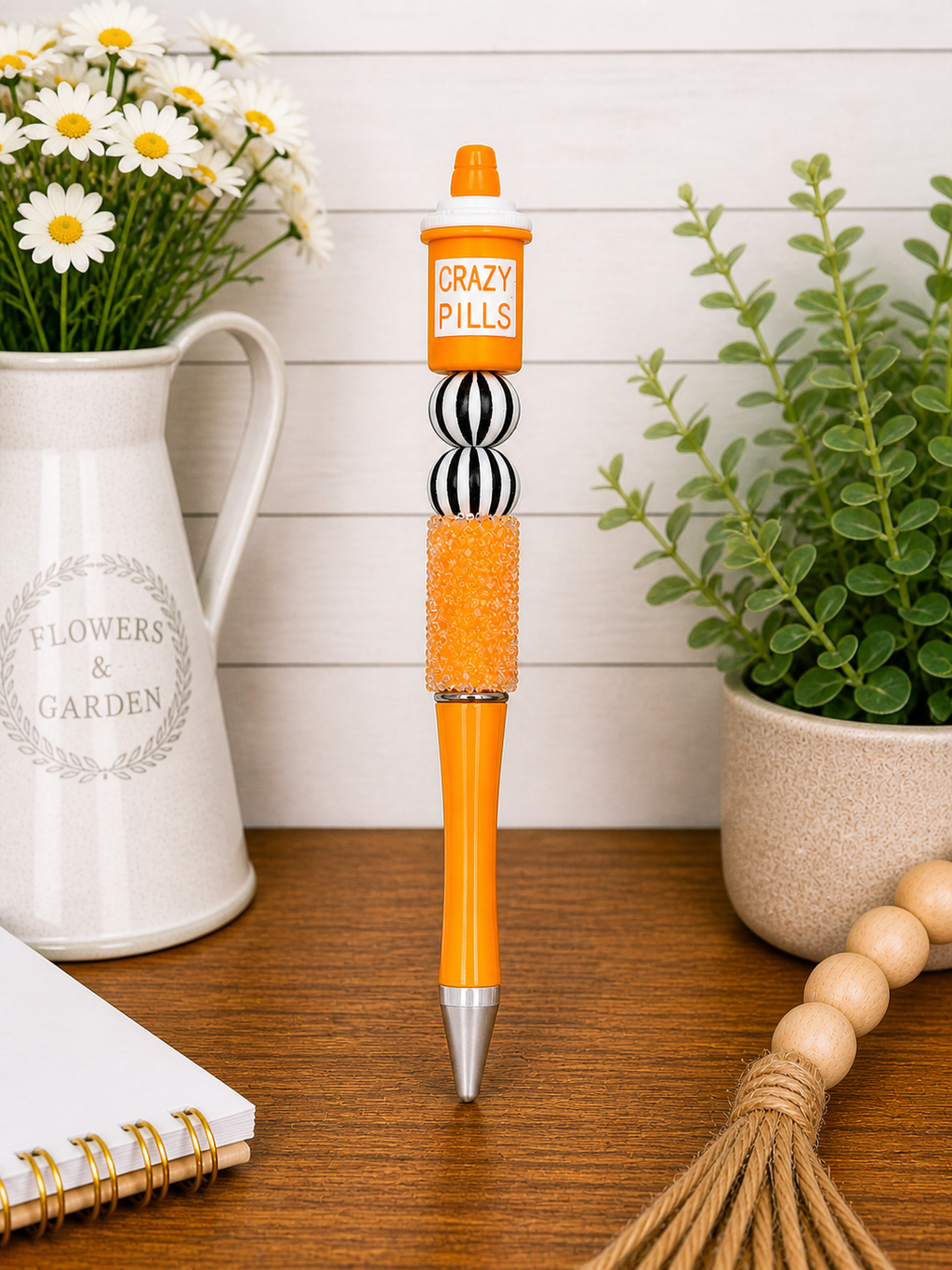 Full orange glitter pen with 'CRAZY PILLS' cap, striped barrel