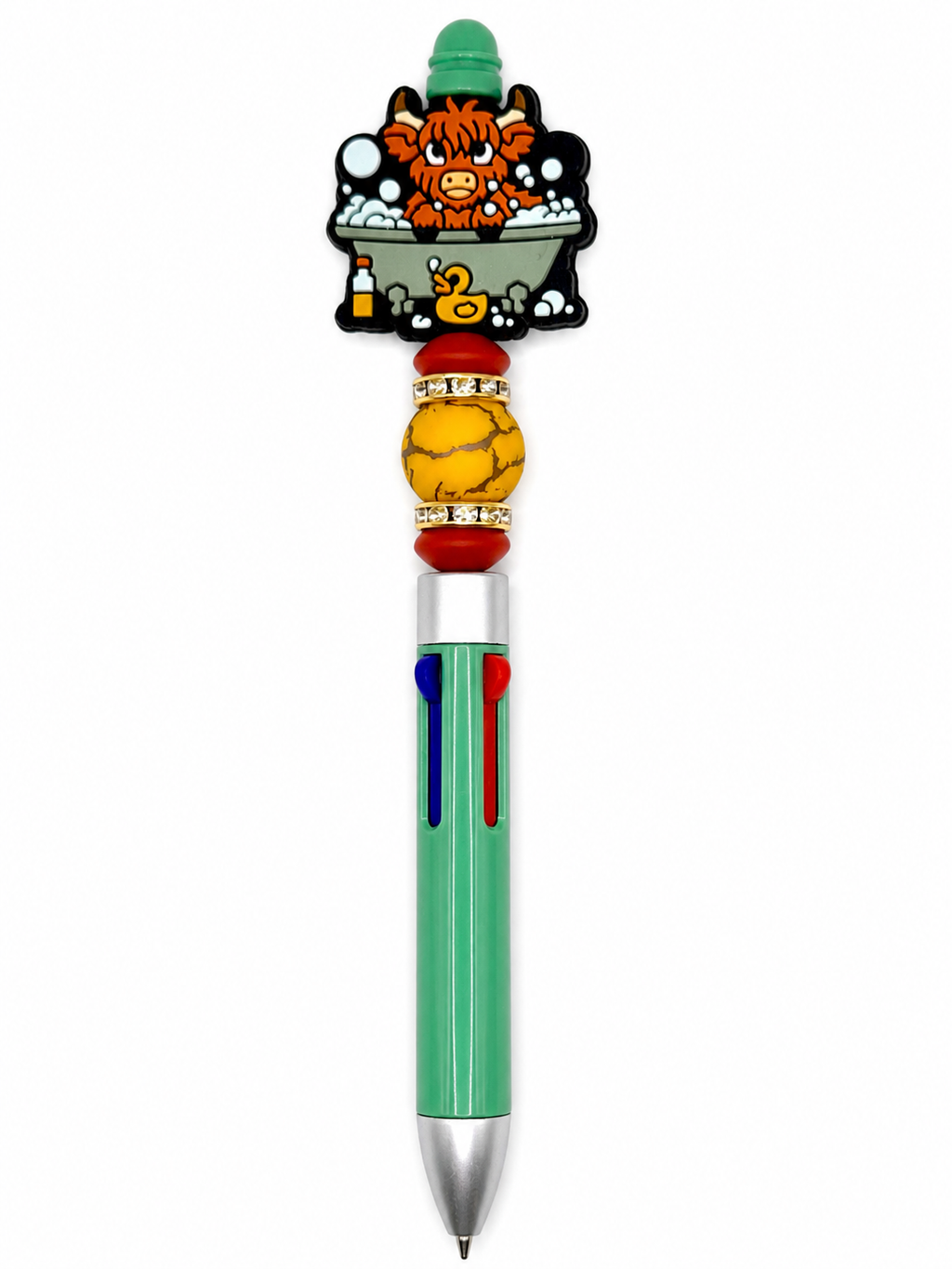 Novelty cow-themed pen with green barrel, black topper, and yellow decorative bead grip