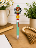 Decorative novelty pen with green barrel and cartoon cow topper; includes yellow bead grip