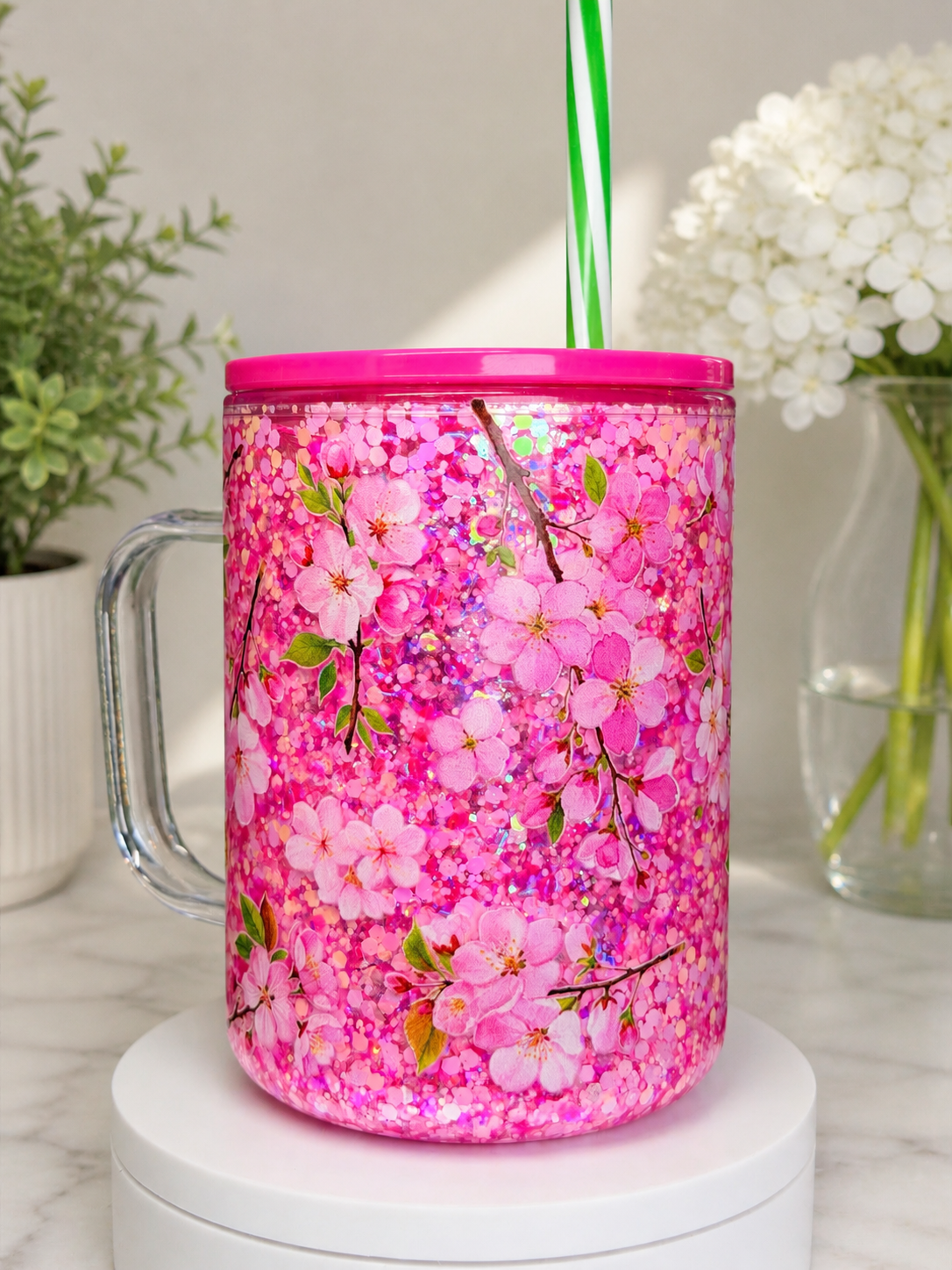 Pink 17 oz coffee mug with floral glitter pattern, magenta lid and clear straw