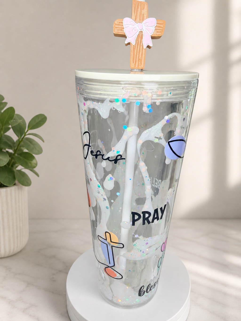 Clear acrylic lava tumbler with glitter speckles, wooden cross topper, and bow