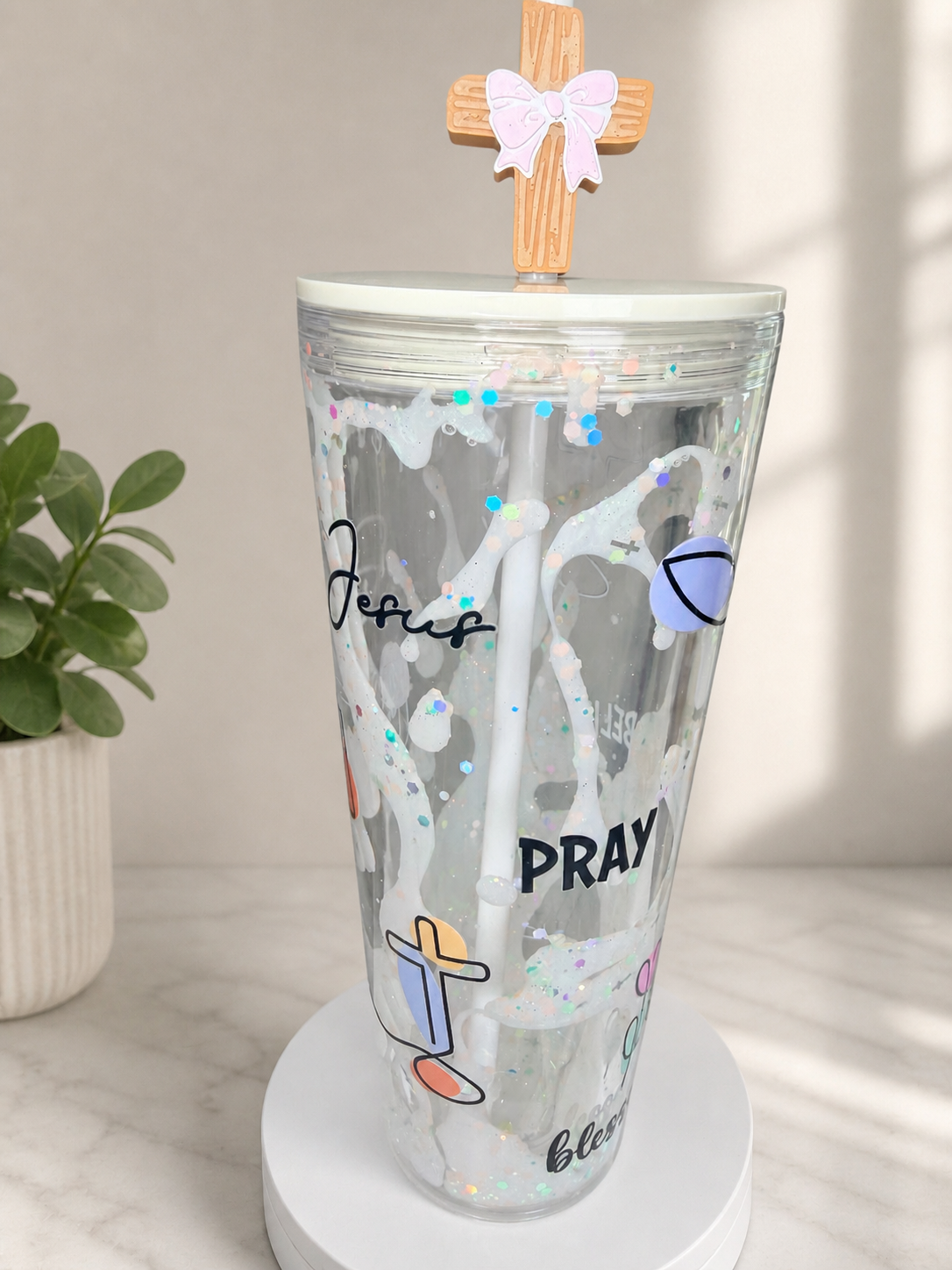 Clear acrylic lava tumbler with glitter speckles, wooden cross topper, and bow