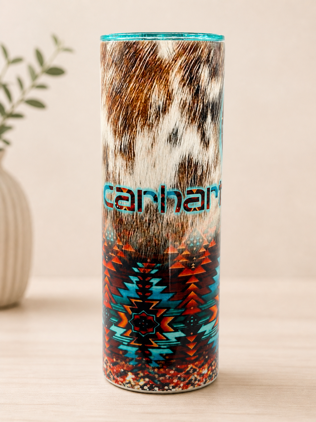 Western-style stainless steel cup with turquoise rim and teal geometric pattern