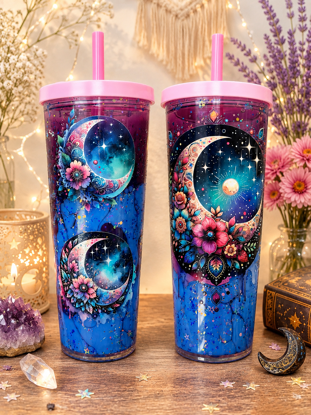 Two 24oz acrylic tumblers with pink lids, galaxy moon floral designs, side by side