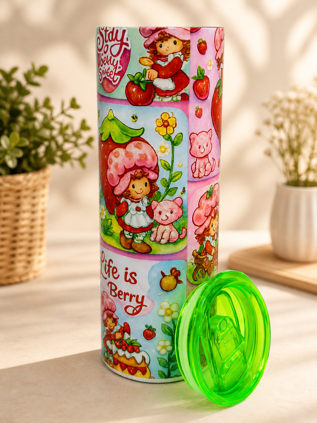 20 oz stainless steel tumbler, green flip-top lid; colorful strawberry character print