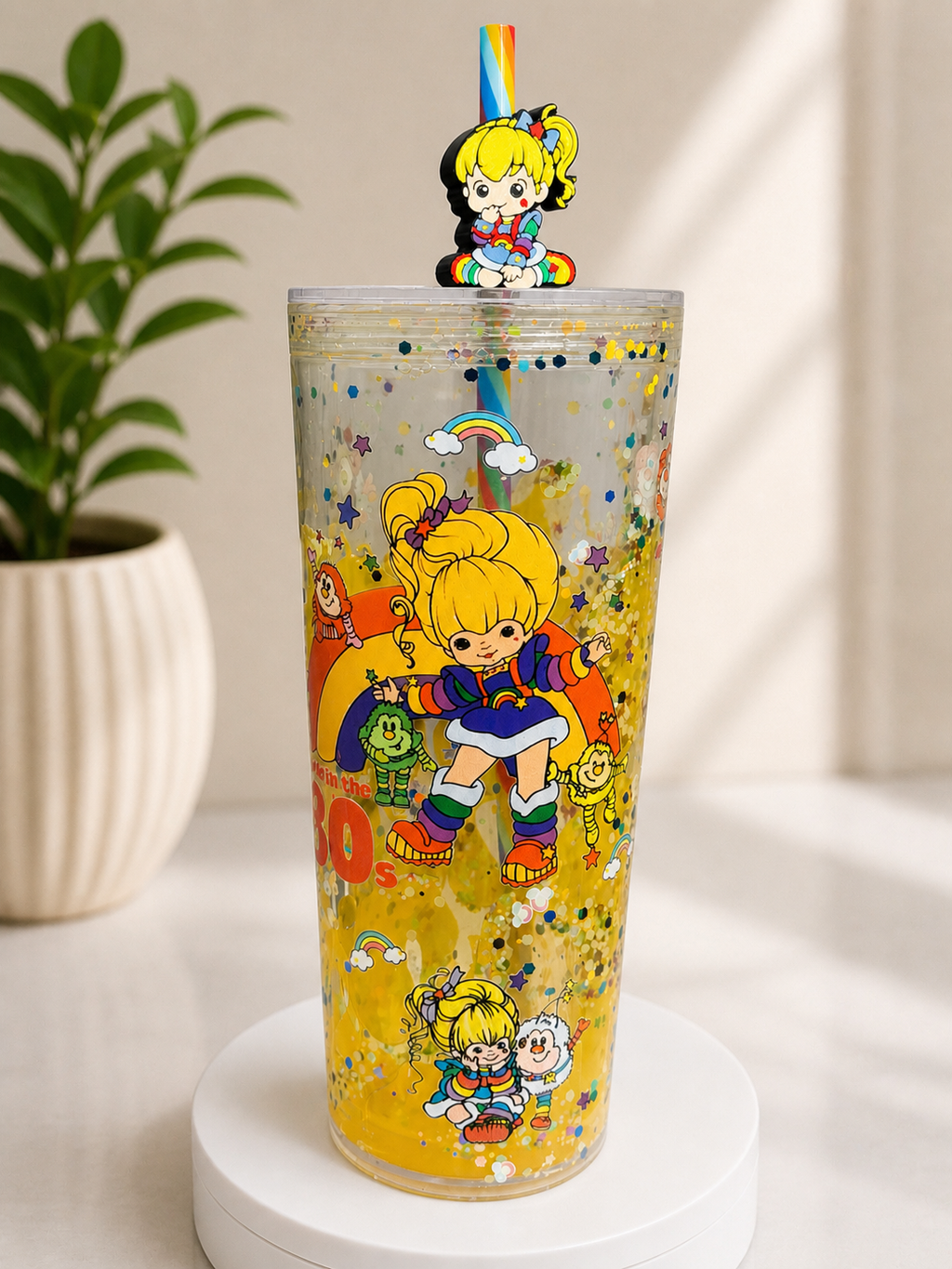 Lava snow globe cup with yellow glitter and Rainbow Brite character graphics, rainbow straw