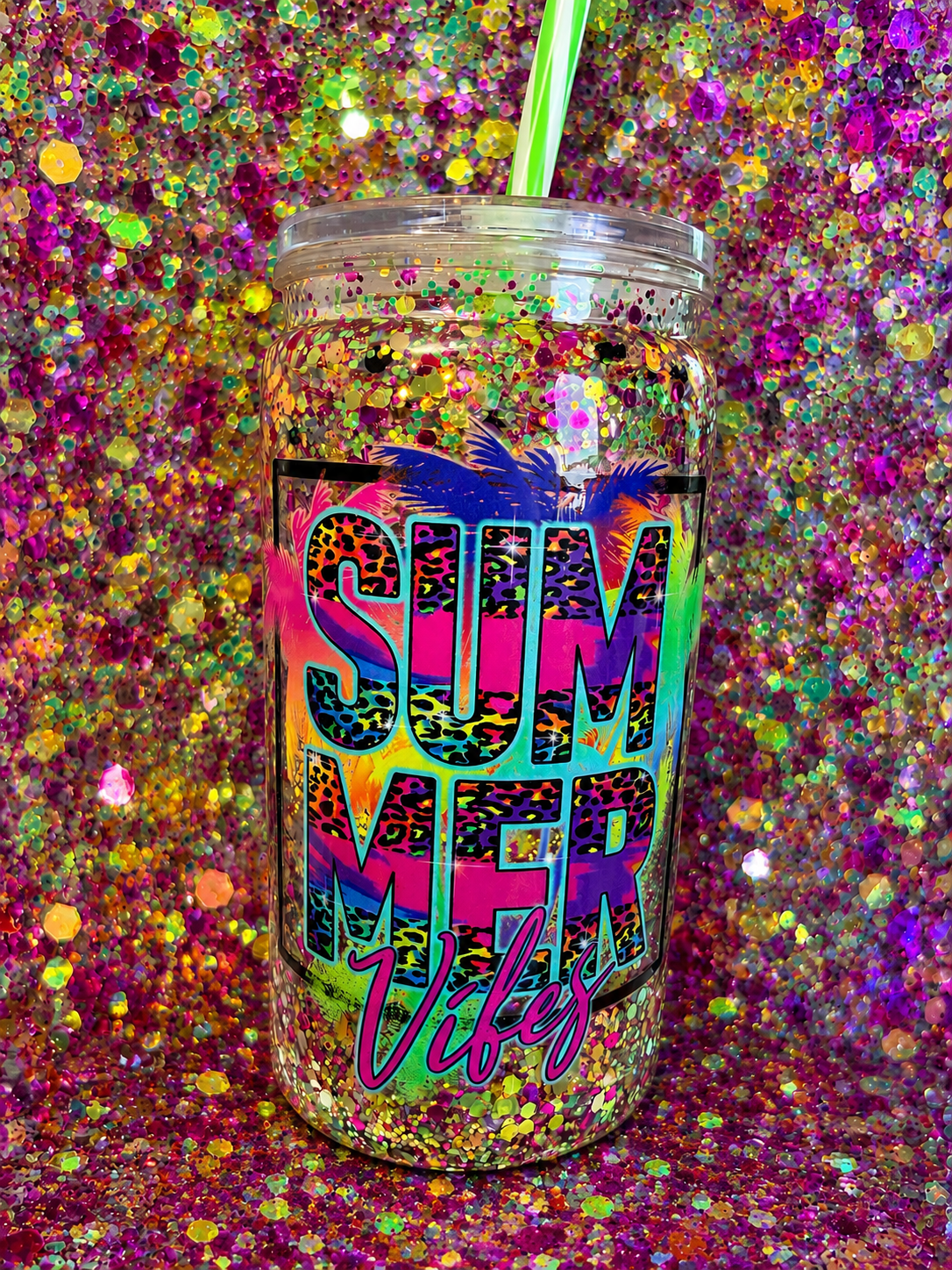 Acrylic snow globe tumbler showing SUMMER Vibes text, clear lid and green straw