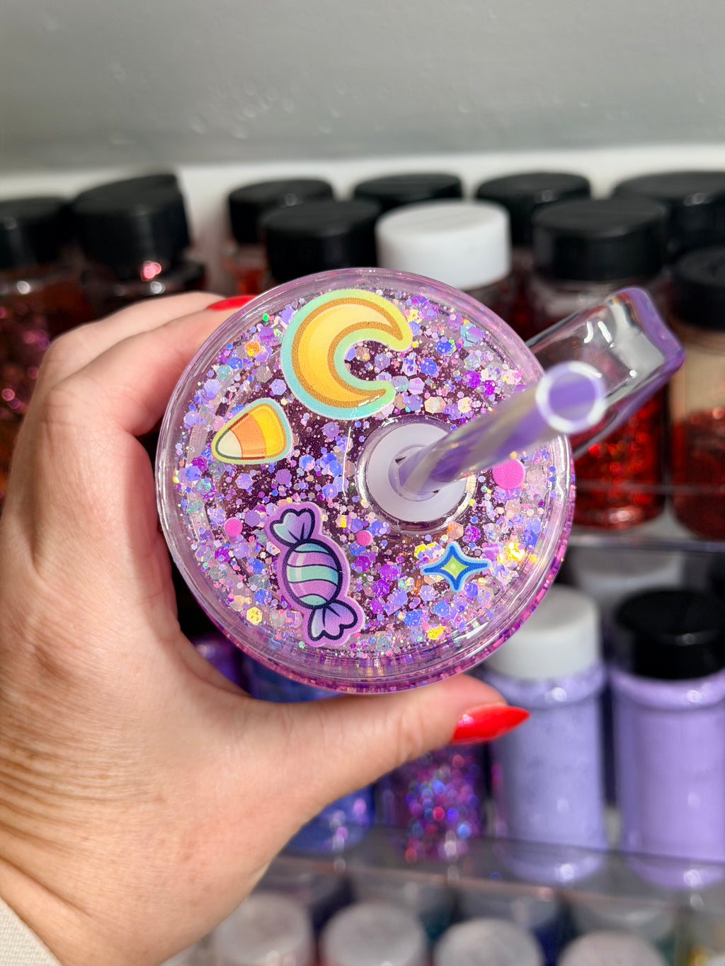 Purple glitter snow globe tumbler lid with straw, swirling C letter design