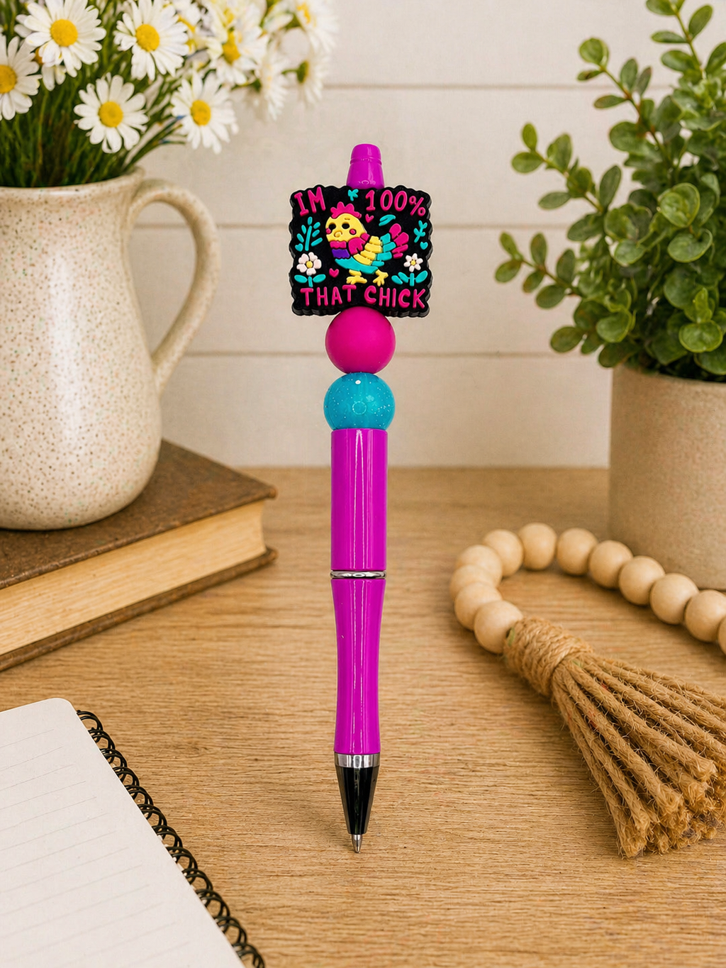 Chick-themed magenta ballpoint pen with decorative chick cap and teal bead
