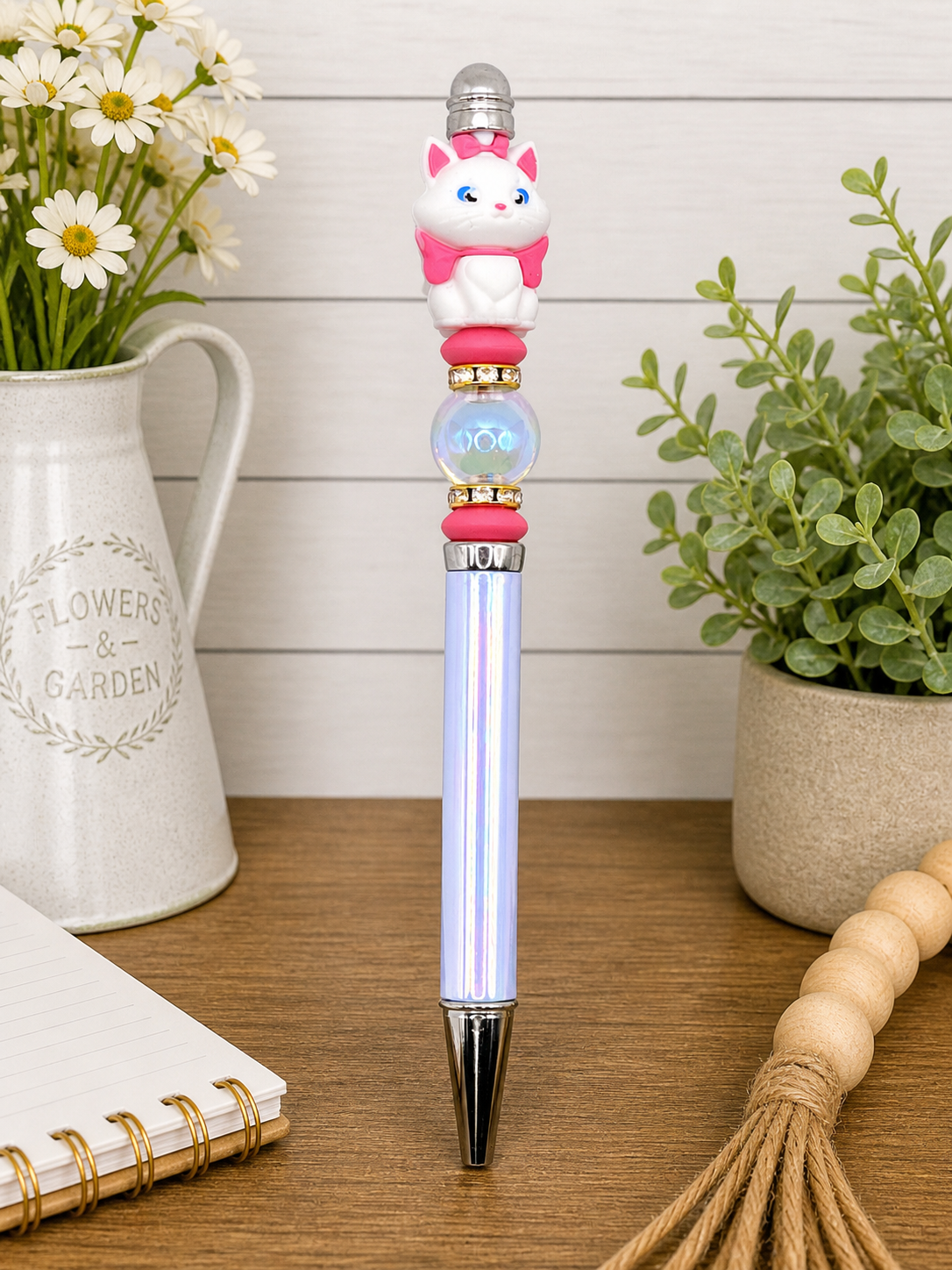 Cat pen with white cat topper, pink scarf, blue barrel, stacked gold charm accents