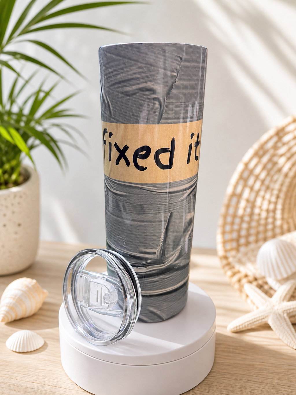 Stainless steel cup with clear lid, sleeve printed with 'Fixed it'