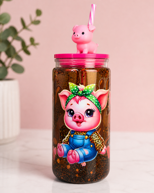 Acrylic snow globe tumbler with pink lid, straw, and pig topper; pig artwork inside