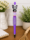 Purple rhinestone pen with raised animal figurine and pointed black tip