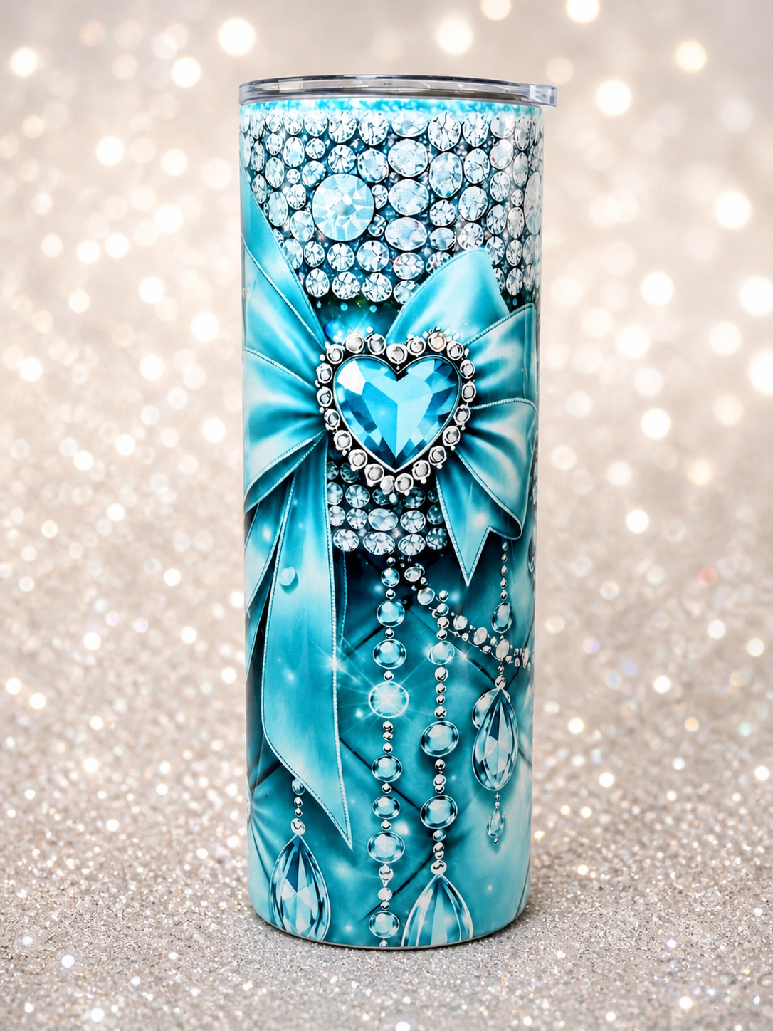 Blue stainless steel tumbler with rhinestone heart, bow, and hanging bead accents