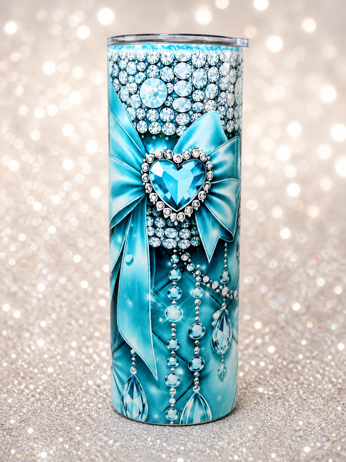 Blue stainless steel tumbler with rhinestone heart, bow, and hanging bead accents