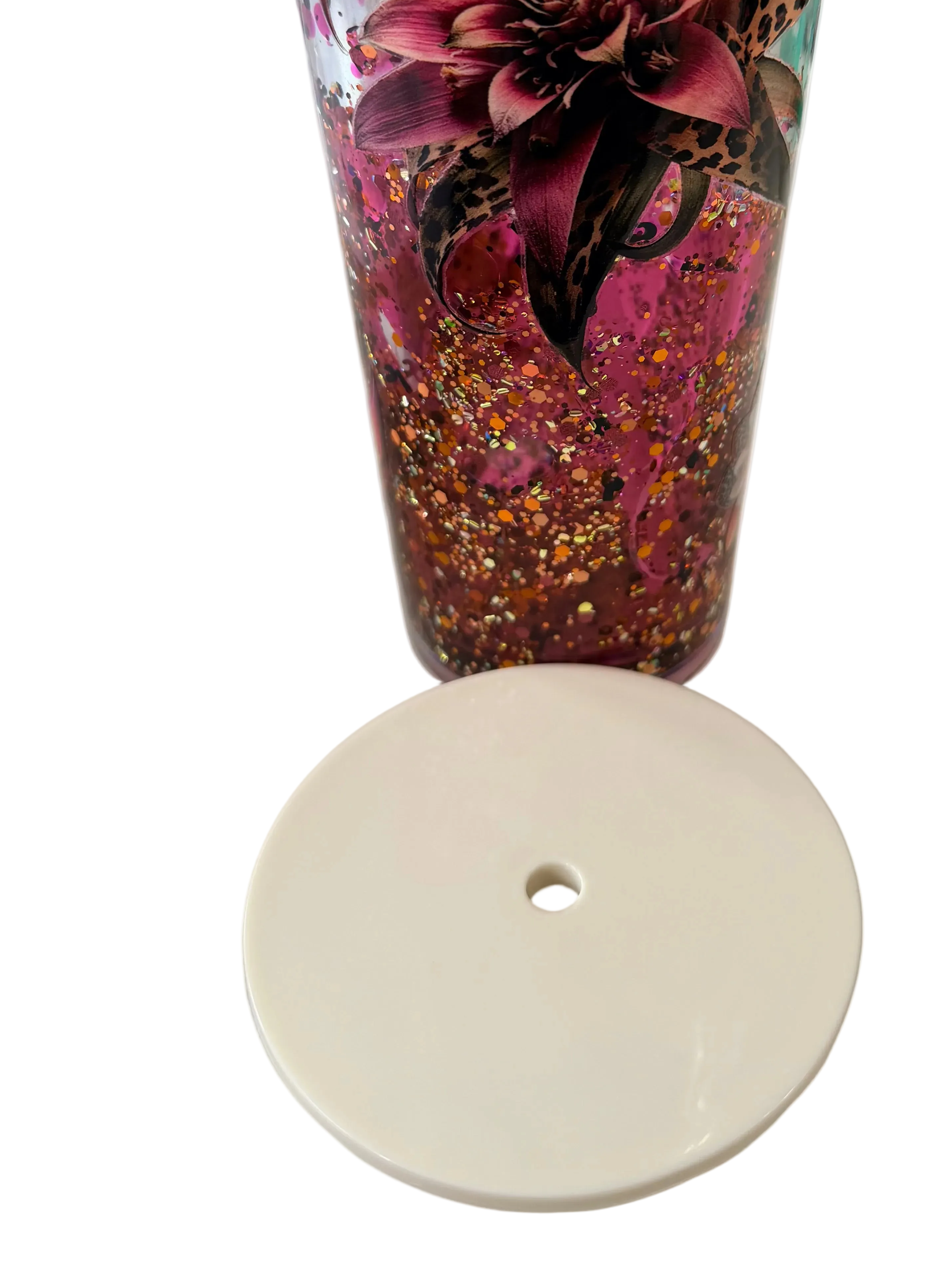 Bottom view of purple glitter tapered acrylic tumbler with floral cheetah design, white base
