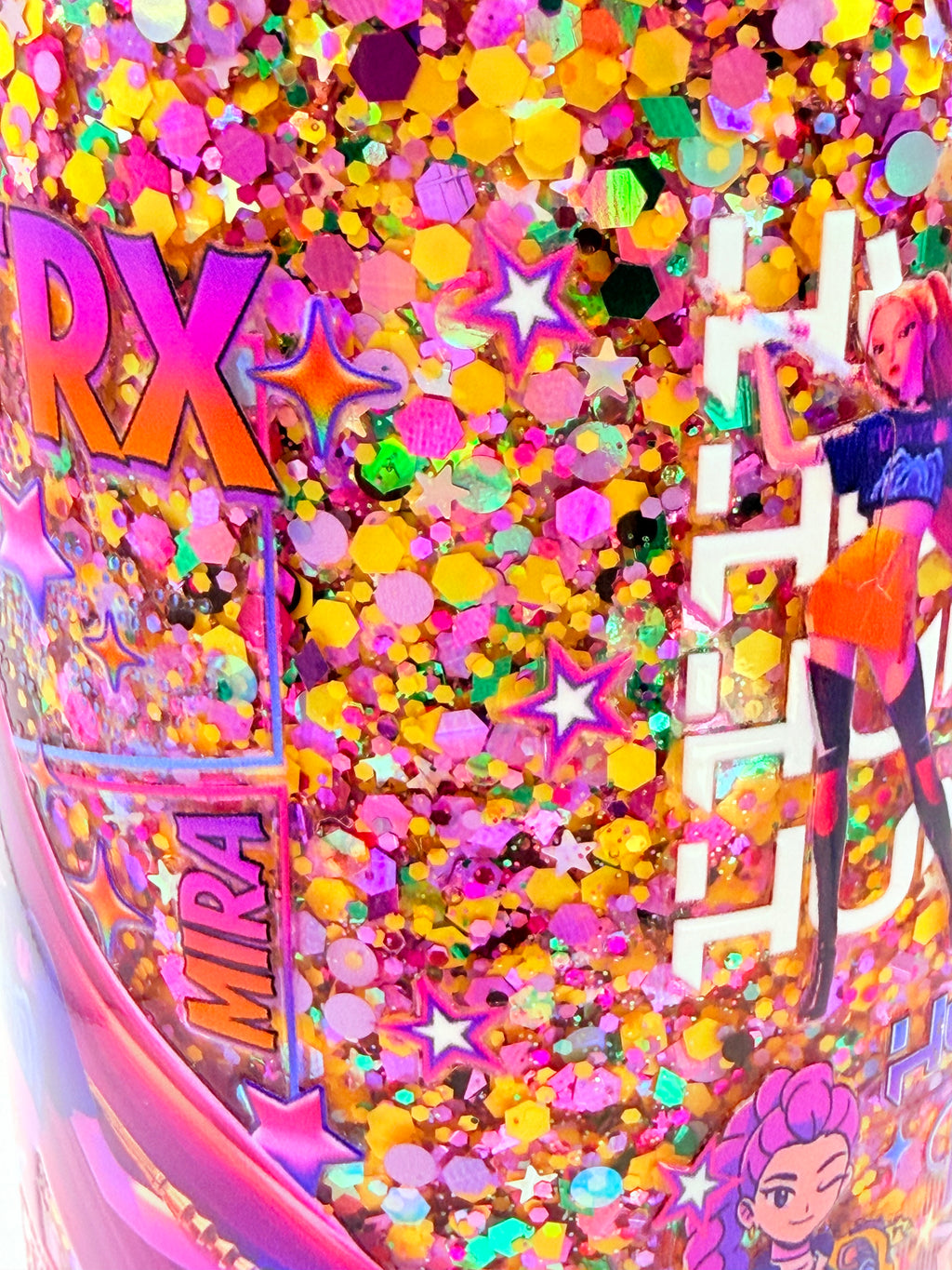 Close-up glitter acrylic snow globe cup with star accents and character artwork
