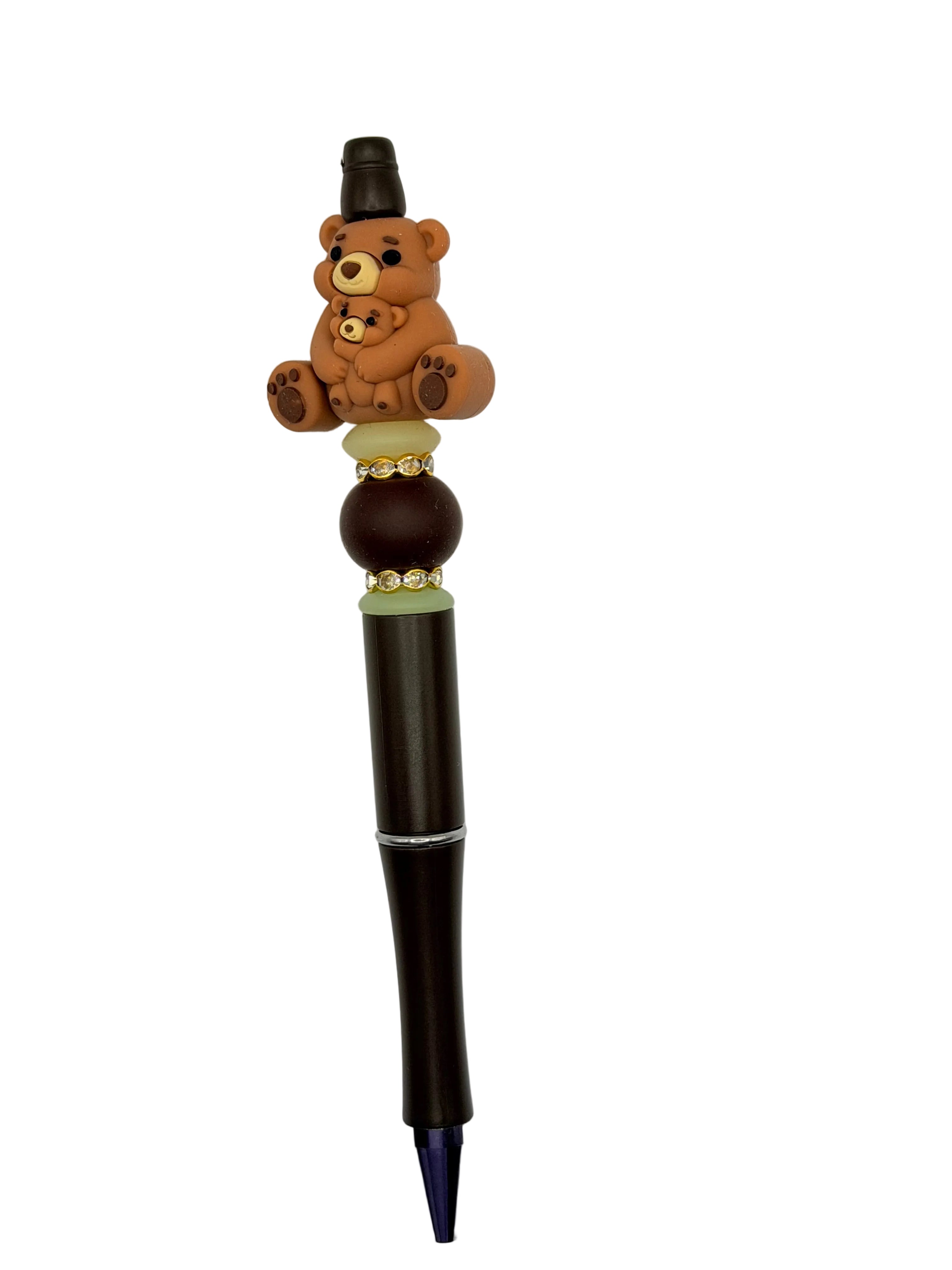 Bear pen with black barrel, teddy bear topper, and gold and green bead accents.