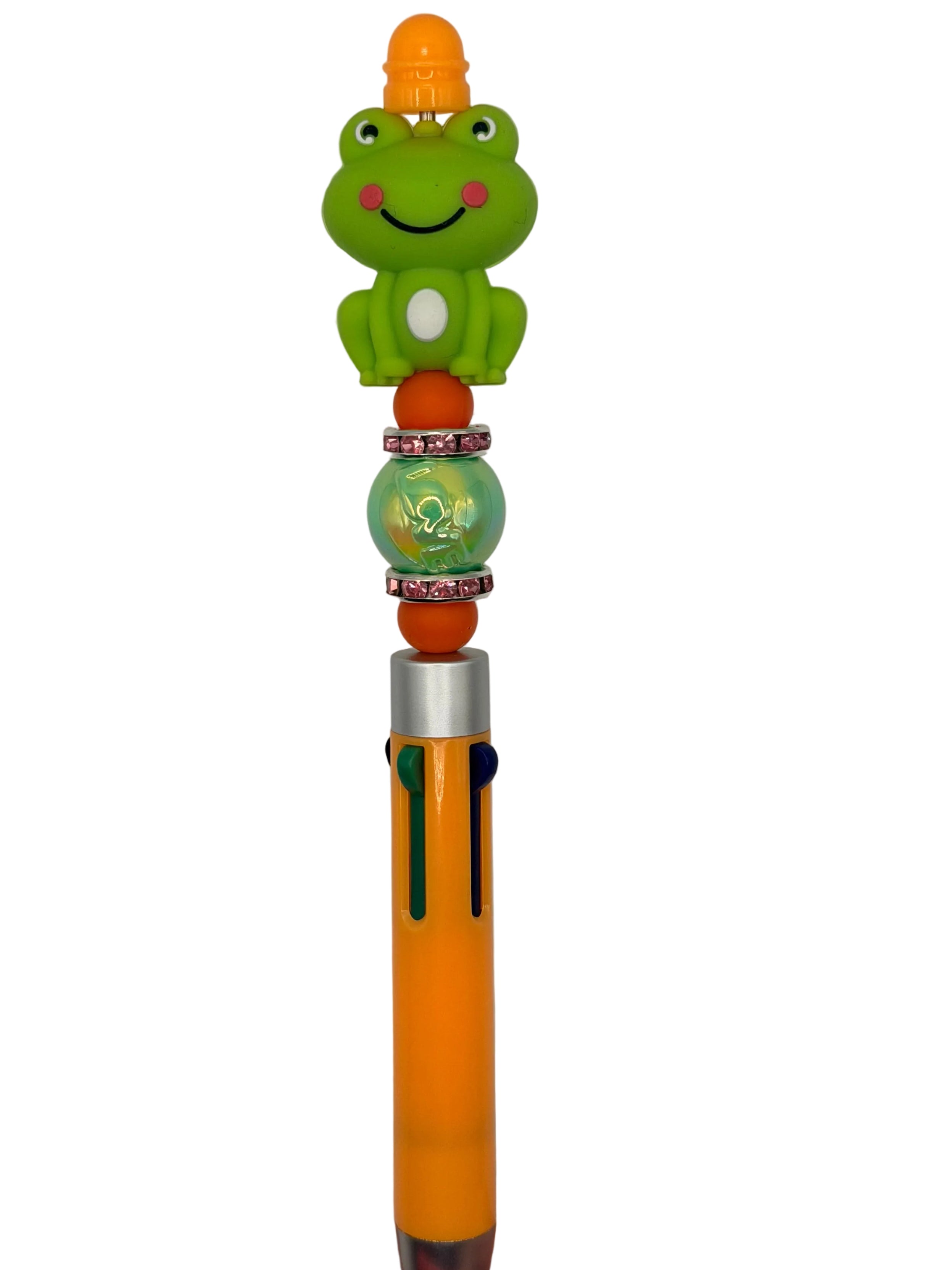Orange pen with smiling green frog topper and blue clip