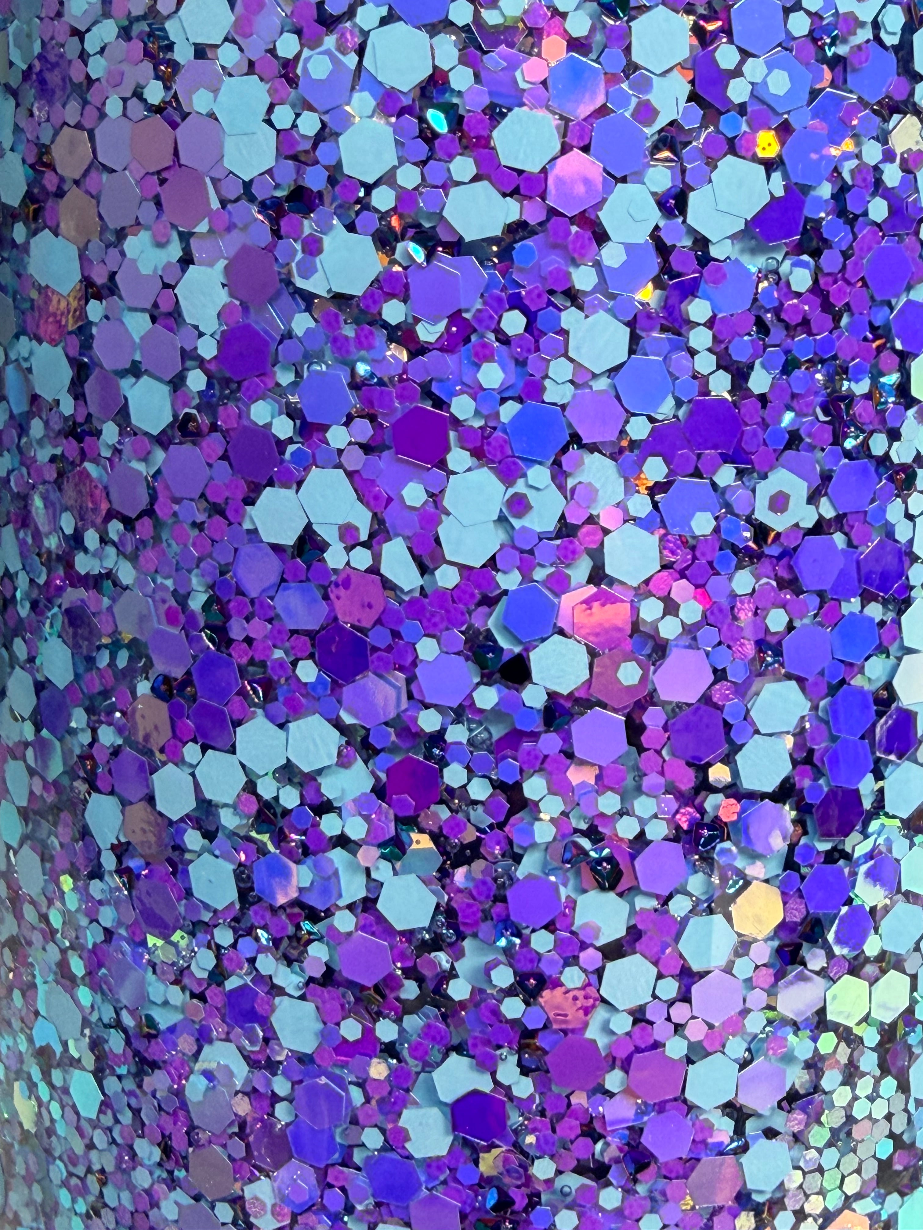 Close-up of multicolor holographic glitter hex confetti on cup surface