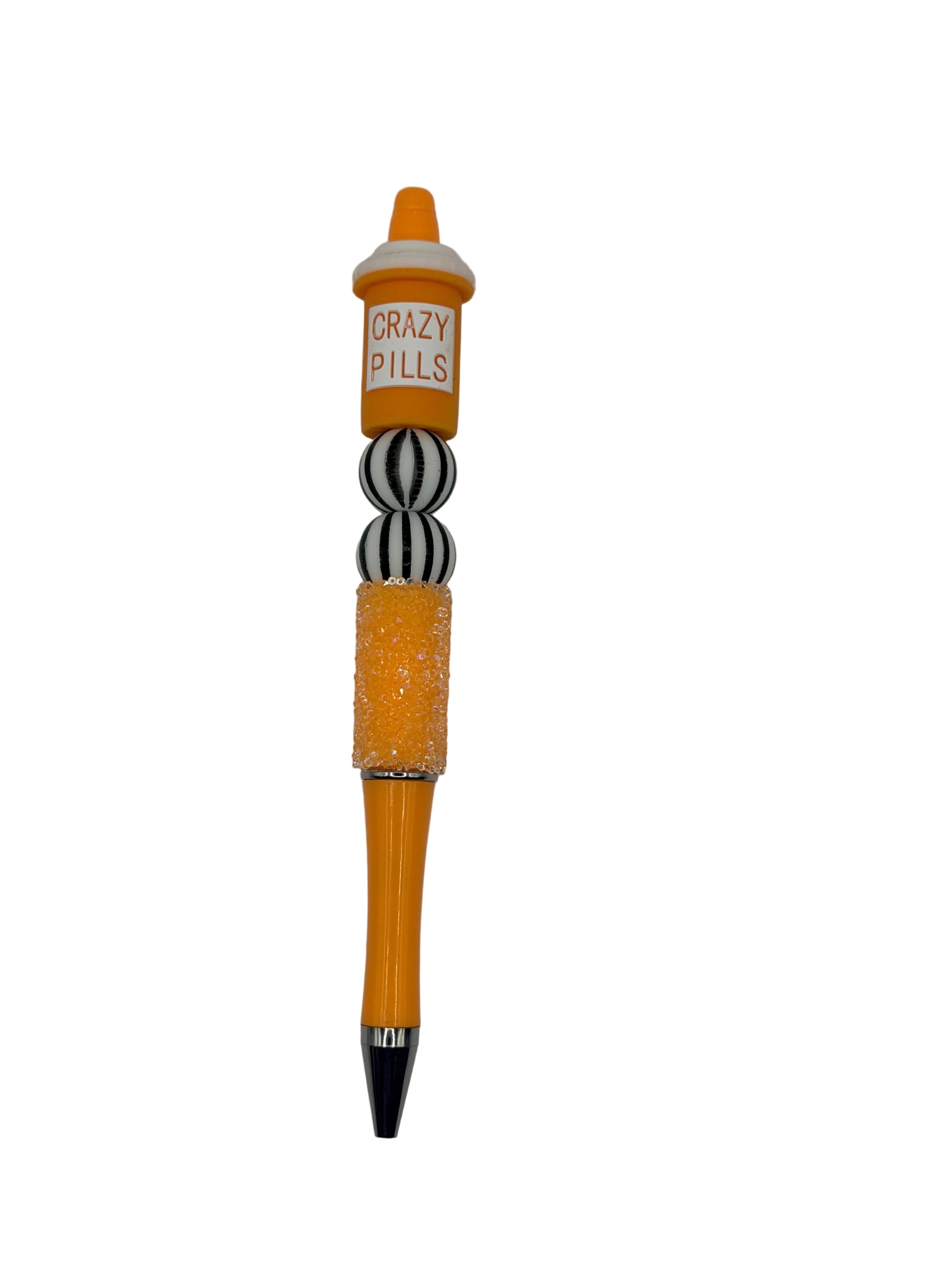 Orange novelty pen: 'CRAZY PILLS' label, glitter barrel, striped grip