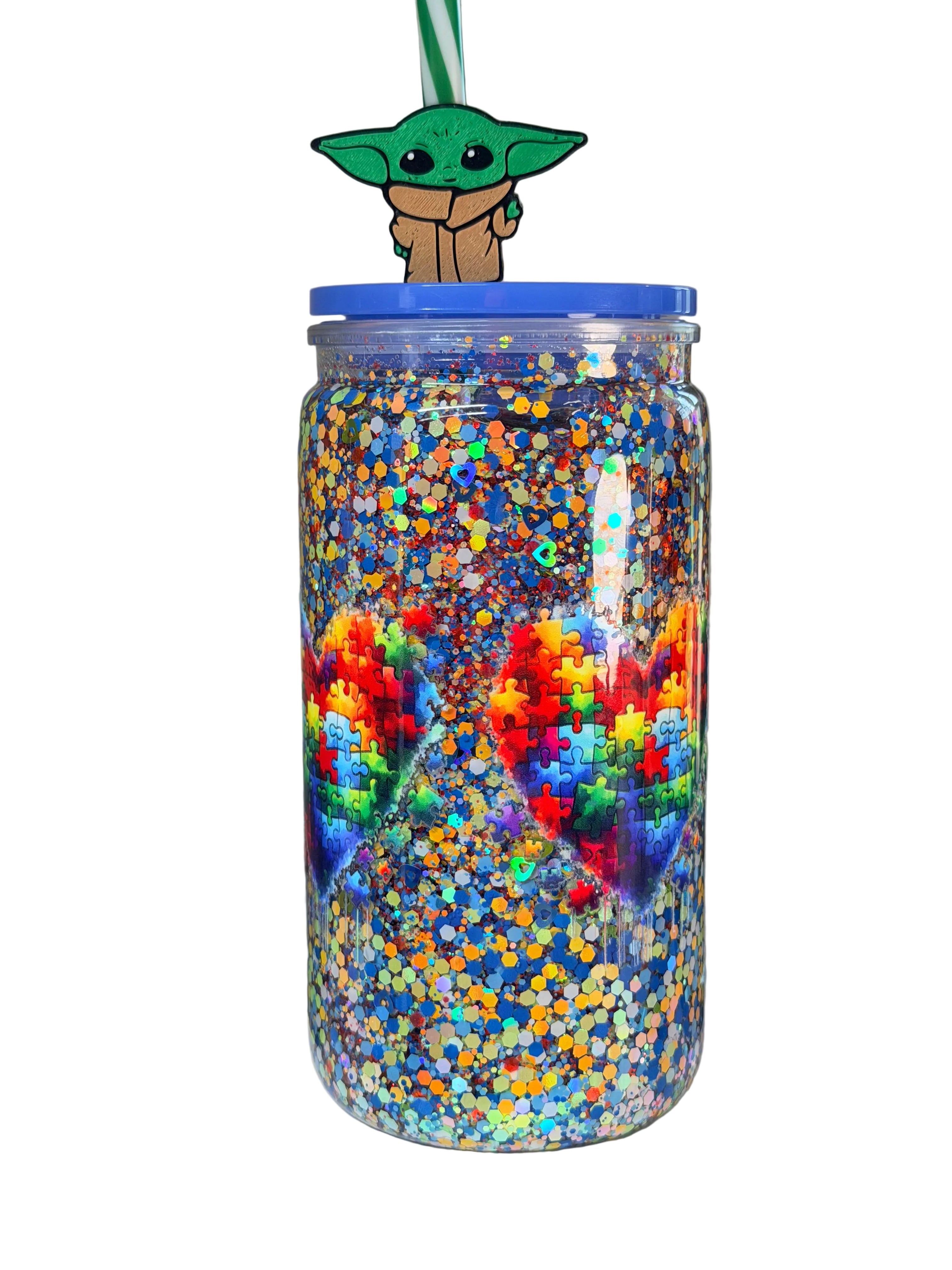 Acrylic snow globe tumbler with blue lid, glitter-filled body in rainbow puzzle colors