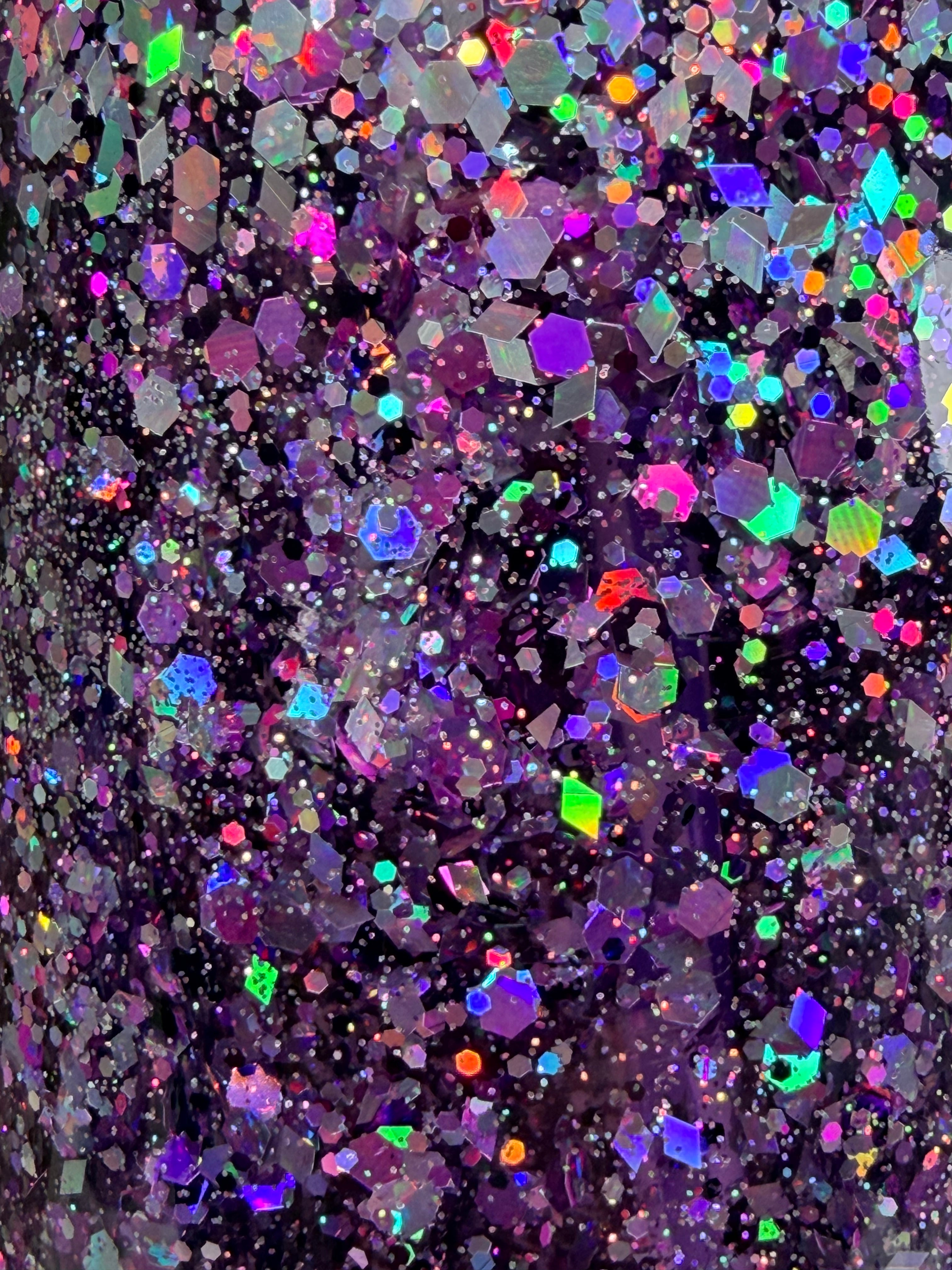 Glitter tumbler cup surface close-up with multicolor sparkles and purple base