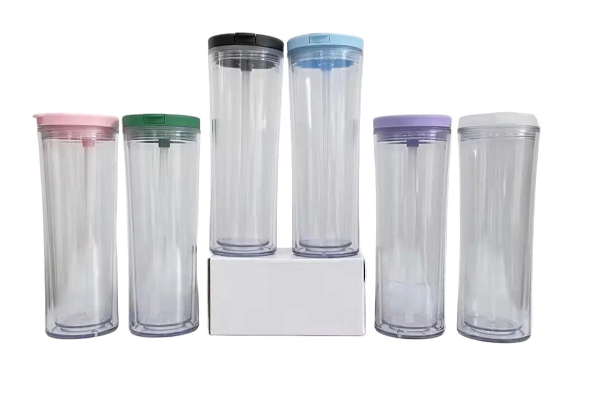 Multiple clear tumblers with colored lids and straws