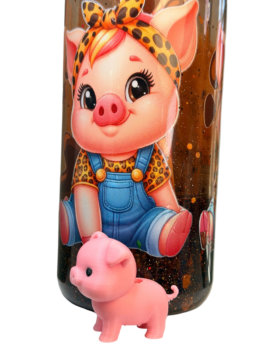 Acrylic snow globe tumbler with pig character and small pig figurine in glitter liquid