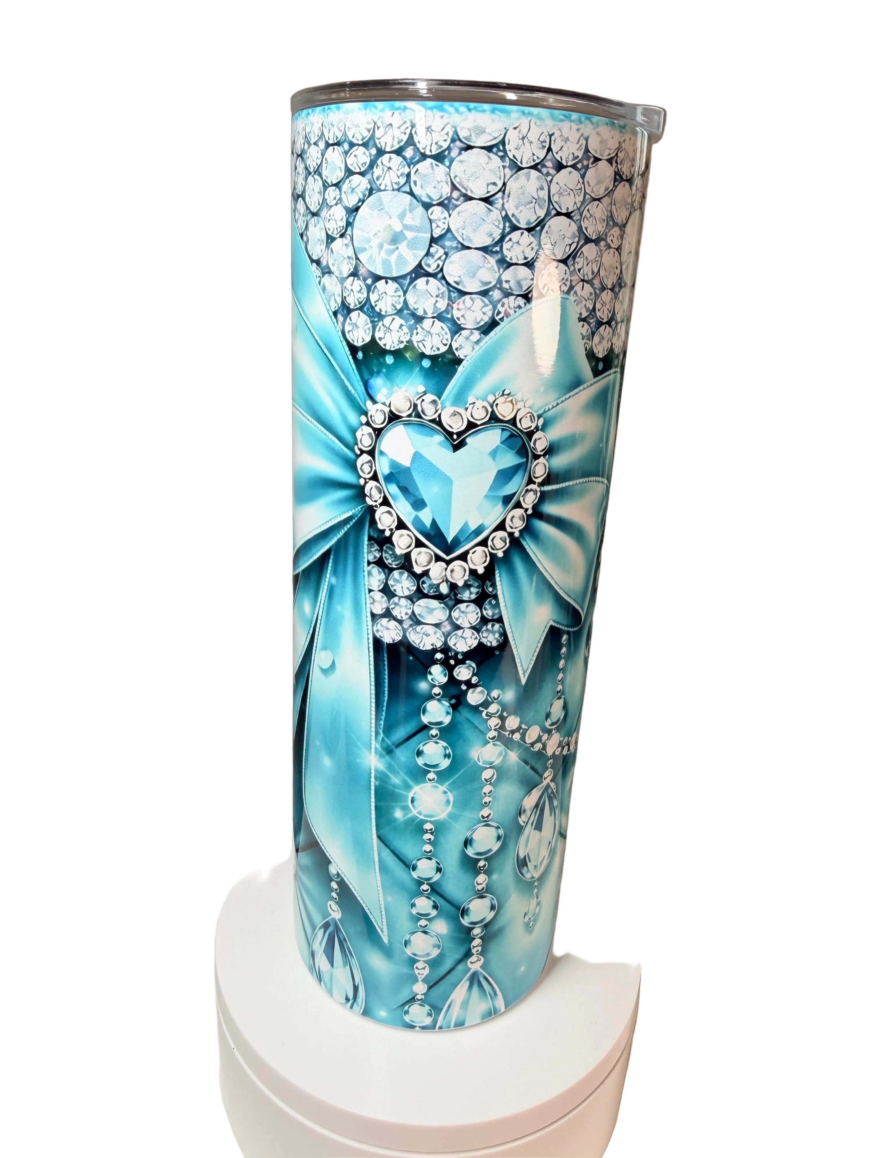Blue stainless steel tumbler with rhinestone bow and heart; diamond-patterned sides